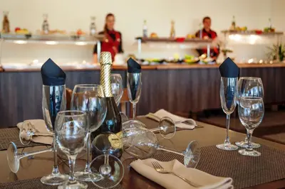 a table with wine glasses and a bottle on it at Viand Hotel - All Inclusive in Sunny Beach