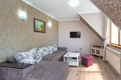a living room with a couch and a staircase at Family Hotel Argo in Varna City