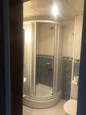 a bathroom with a shower and a toilet at Family Hotel Argo in Varna City