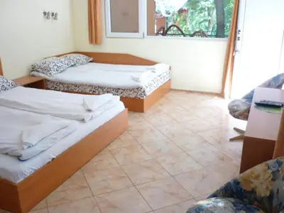 a room with two beds in a room with a window at Nimpha Bungalows in Kamchia