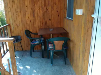 a table and two chairs on a porch at Nimpha Bungalows in Kamchia