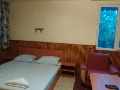 a bedroom with a bed and a chair and a window at Nimpha Bungalows in Kamchia
