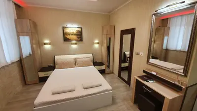 a bedroom with a bed and a large mirror at Deluxe Studios City Center in Burgas City