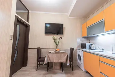 a small room with a table and a kitchen at Deluxe Studios City Center in Burgas City