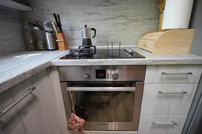 a kitchen with a stove and a counter top at Izgrev Sarafovo in Burgas City