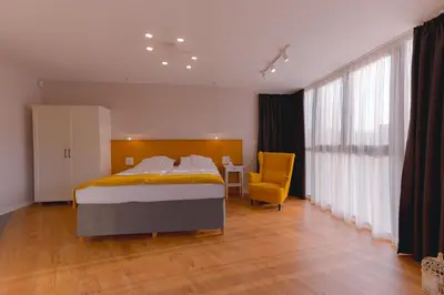 a bedroom with a bed and a table and a chair at B&P studios in Varna City