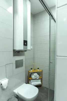 a bathroom with a toilet and a glass shower at B&P studios in Varna City