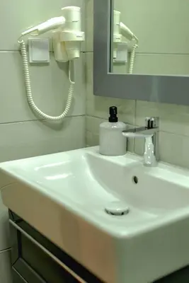 a white sink in a bathroom with a mirror at B&P studios in Varna City