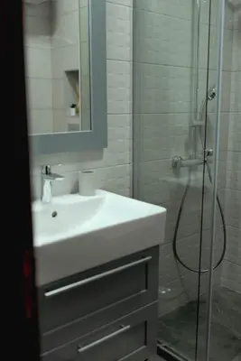 a bathroom with a white sink and a shower at B&P studios in Varna City