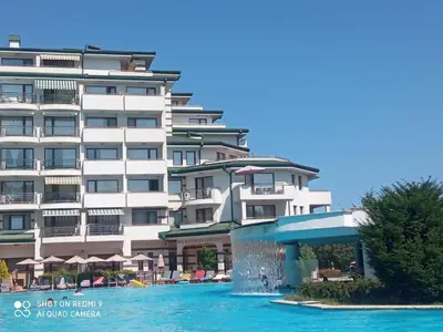 a large building with a water fountain in front of it at Emerald Beach Resort & Spa,studio ikat310 in Ravda