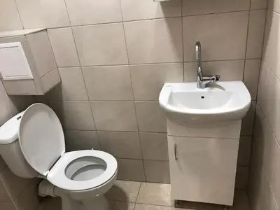 a bathroom with a toilet and a sink at Студио Чайка Бургас Център in Burgas City