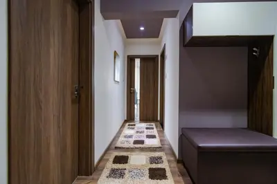 a hallway with a stairwell with a door and a rug at Cosy Luxury Flat in the Centrum- 90sqm - 3 rooms. in Varna City