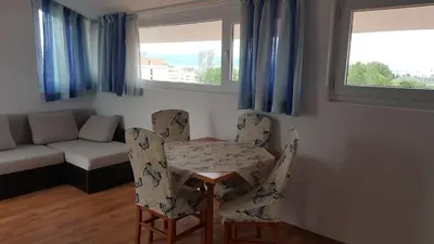 a living room with a table and chairs and a couch at Beautiful Penthouse Apartment in Sunny Beach