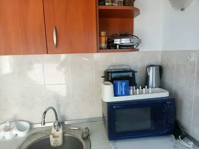 a kitchen with a sink and a microwave at Beautiful Penthouse Apartment in Sunny Beach