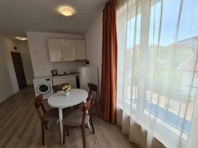 a small kitchen with a table and a window at MIDA Apartment in Obzor