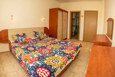 a bedroom with a bed with a colorful bedspread at Prestige City 1BD Apt with POOL near to Cacao Beach by Flаt Manаger in Sunny Beach