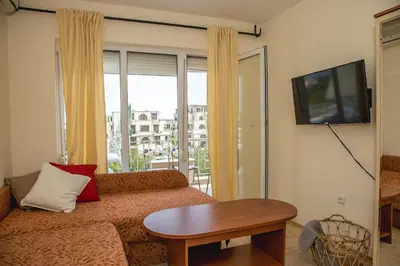 a living room with a couch and a tv at Prestige City 1BD Apt with POOL near to Cacao Beach by Flаt Manаger in Sunny Beach