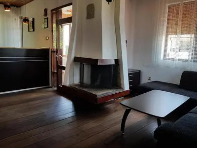 a living room with a fireplace and a couch at Апартамент Емилия in Sozopol