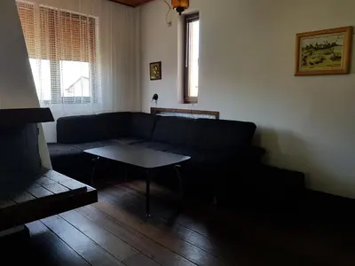 a living room with a couch and a table at Апартамент Емилия in Sozopol
