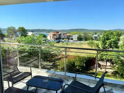 a balcony with chairs and a view of a city at Ancient well in Sozopol