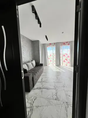 a living room with a couch and a window at Ancient well in Sozopol