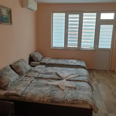 a bedroom with two beds with a starfish on it at Къща за гости Оазис in Pomorie