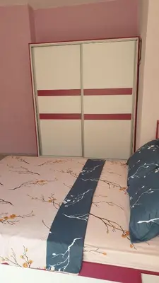 a bed with two pillows on top of it at Къща за гости Оазис in Pomorie
