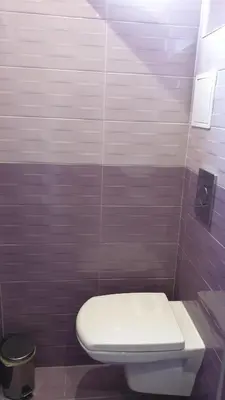 a bathroom with a white toilet in a stall at Къща за гости Оазис in Pomorie