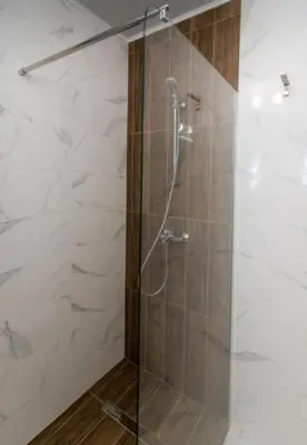 a shower with a glass door in a bathroom at Apartment Galia in Burgas city center in Burgas City