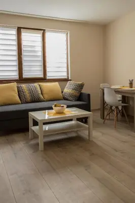 a living room with a couch and a coffee table at Margis Home in Burgas City