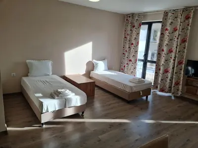 a bedroom with two beds and a window at Ilarion 5 studio at Top Center in Varna City