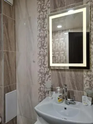a bathroom with a sink and a mirror at Ilarion 5 studio at Top Center in Varna City