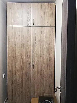 a bathroom with a wooden cabinet with a toilet at Ilarion 5 studio at Top Center in Varna City
