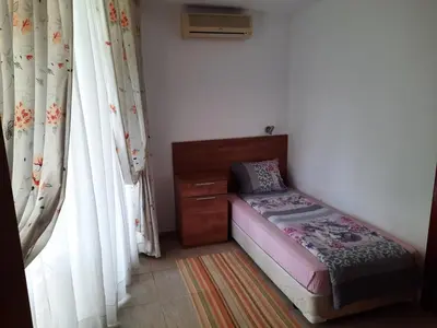 a small bedroom with a bed and a dresser and curtains at Apartment in Sunny beach, Complex Sun Village, 80 qm, 2 bedrooms & living room near to the beach, SWIMMING POOL, garden in Sunny Beach