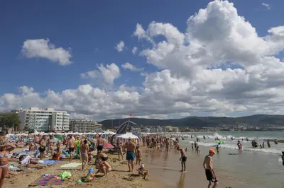 a large group of people on a beach at Apartment in Sunny beach, Complex Sun Village, 80 qm, 2 bedrooms & living room near to the beach, SWIMMING POOL, garden in Sunny Beach