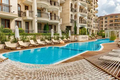 a swimming pool in the middle of a building at Menada Harmony Suites X in Burgas City