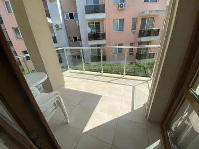 a balcony with a view of a building at Beautiful Sun Village with sea view in Byala