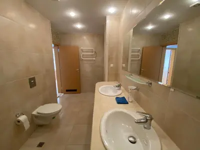a bathroom with a sink and a toilet and a mirror at Beautiful Sun Village with sea view in Byala