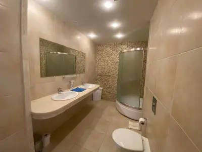 a bathroom with two sinks and a toilet and a mirror at Beautiful Sun Village with sea view in Byala