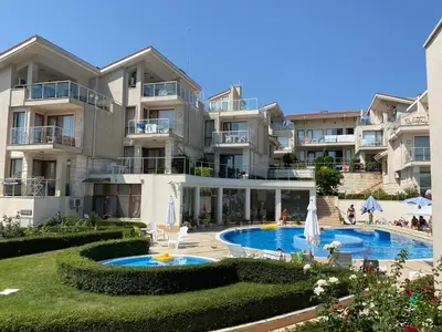 a large apartment building with a swimming pool at Beautiful Sun Village with sea view in Byala