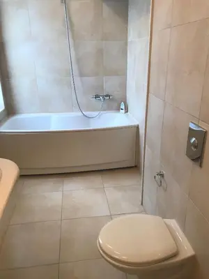 a bathroom with a shower and a toilet and a tub at Sun Village Villa 13 in Byala