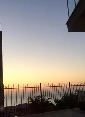 a fence with the sunset in the background at Sun Village Villa 13 in Byala