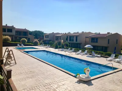 a swimming pool with a swan in the middle at Arapya Beach Apartment in Tsarevo