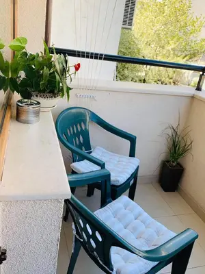 two chairs and a table on a balcony at RELAX CENTER Burgas & Free PARKING in Burgas City