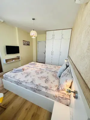a bedroom with a bed and a tv at ROMANCE APARTAMENT & Free Parking in Burgas City