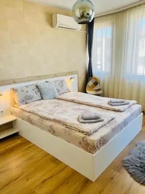 a bedroom with a large bed in a room at ROMANCE APARTAMENT & Free Parking in Burgas City