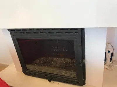 a fireplace in a room with a white wall at Sun Village Villa 6 in Byala