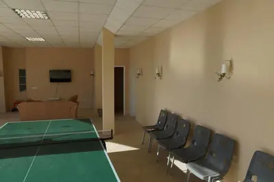 a conference room with a green table and chairs at Sun Village Villa 6 in Byala
