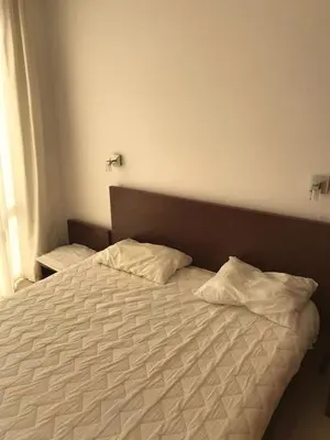a bed with two pillows on it in a bedroom at Sun Village Villa 6 in Byala