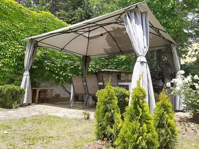 a gazebo with a table and chairs under it at Milennia Family Hotel in Sunny Beach